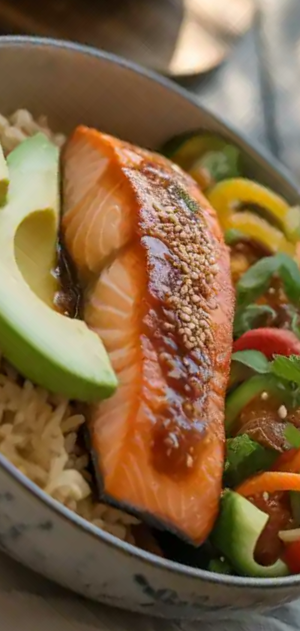 “Healthy baked salmon fillet with chili glaze on top of fluffy rice and roasted veggies”