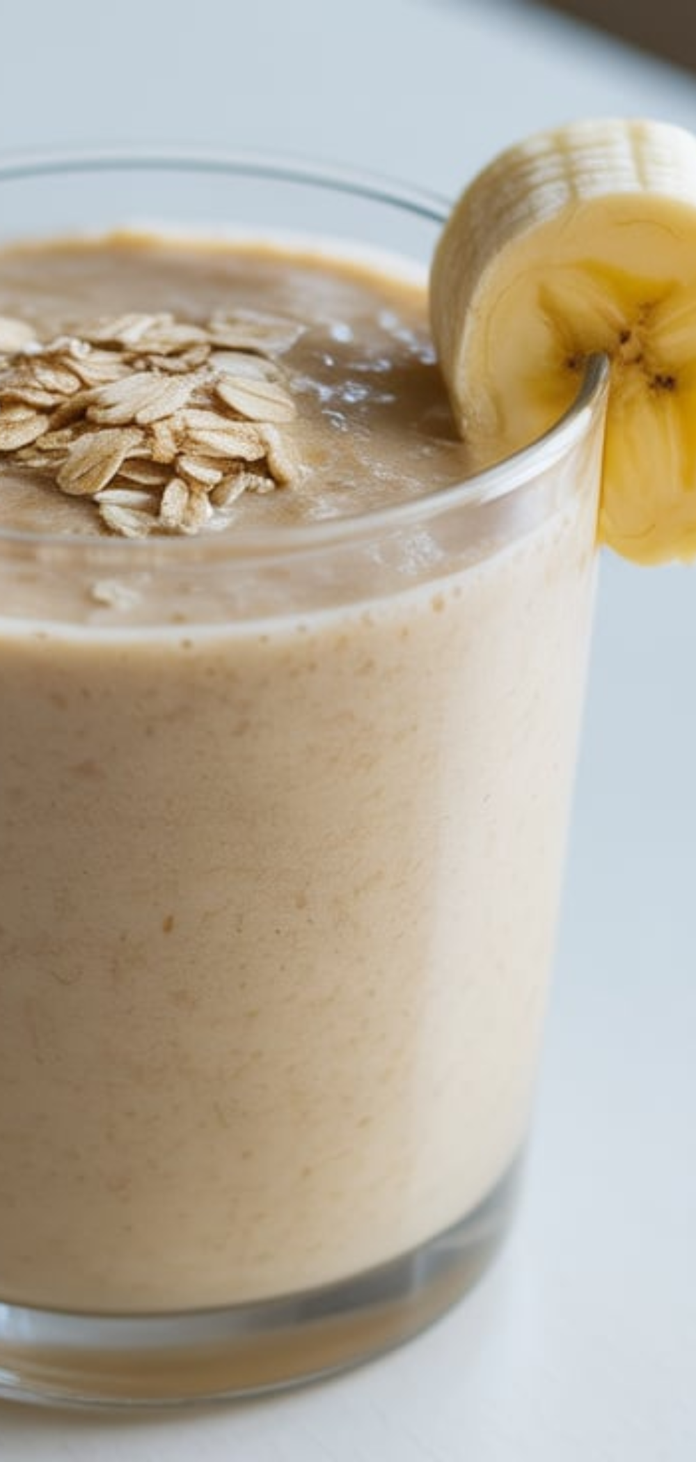 "Refreshing energy smoothie made with spinach, banana, oats, and almond milk, styled in a clean minimal food blogger setup."