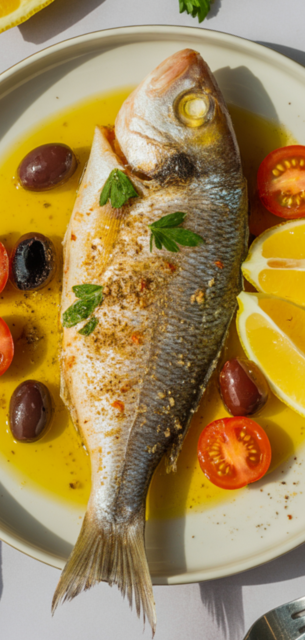 “Healthy Mediterranean fish dinner with lemon and herbs.”