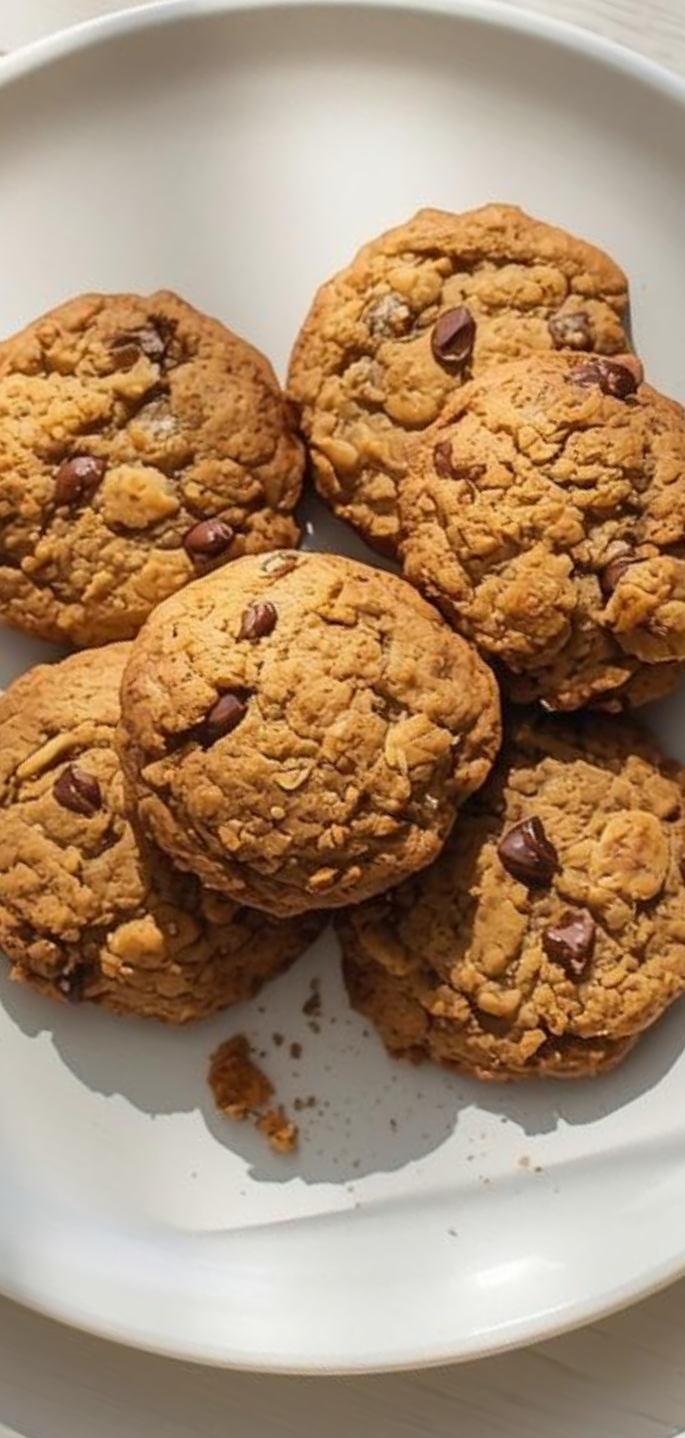 “Healthy Banana Oat Cookies with cinnamon and chocolate chips on a clean white table, styled like a professional food blog shot”
