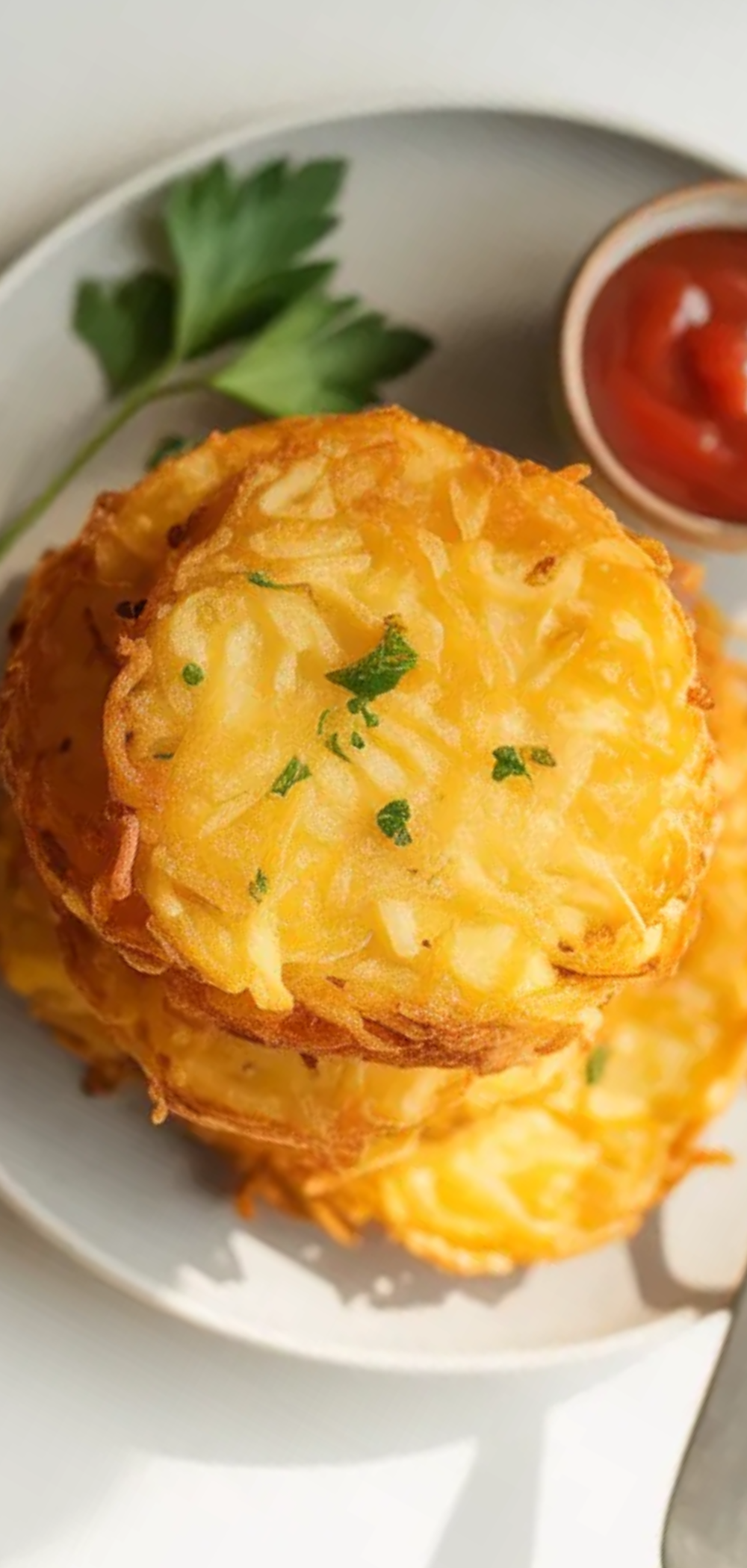 Homemade hash browns with a crunchy texture and soft inside styled in natural light on a clean white background