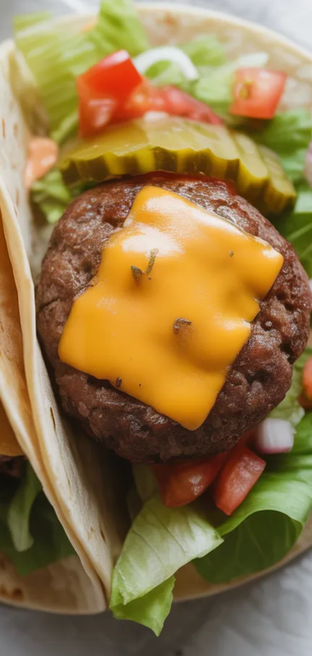 “Juicy homemade smash burger patty inside a folded taco with fresh toppings and sauces, styled like a food blogger photo.”