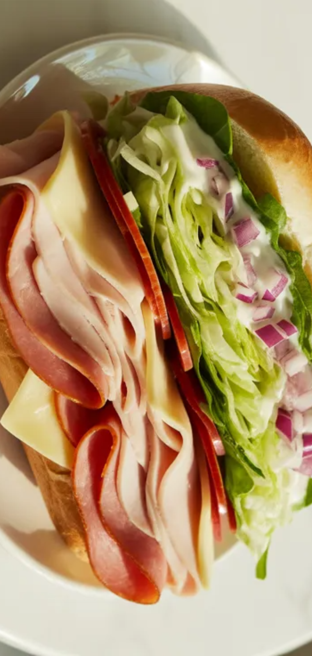 Easy homemade grinder sandwich cut in half showing juicy and crunchy layers inside