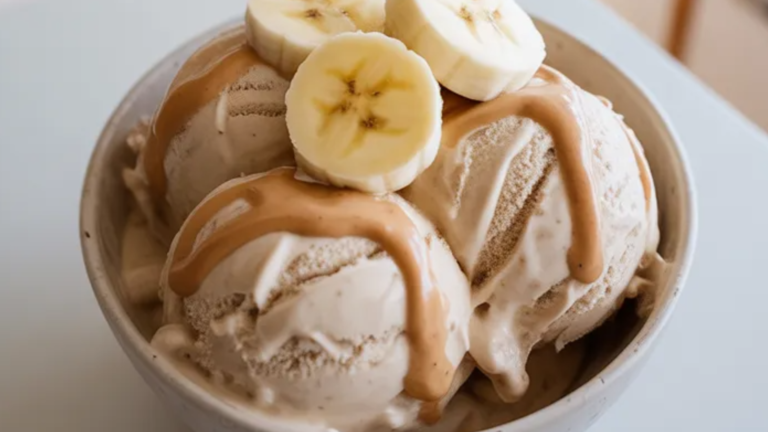 Creamy homemade protein ice cream made with frozen bananas and protein powder served in a bowl on a clean white table with soft natural light