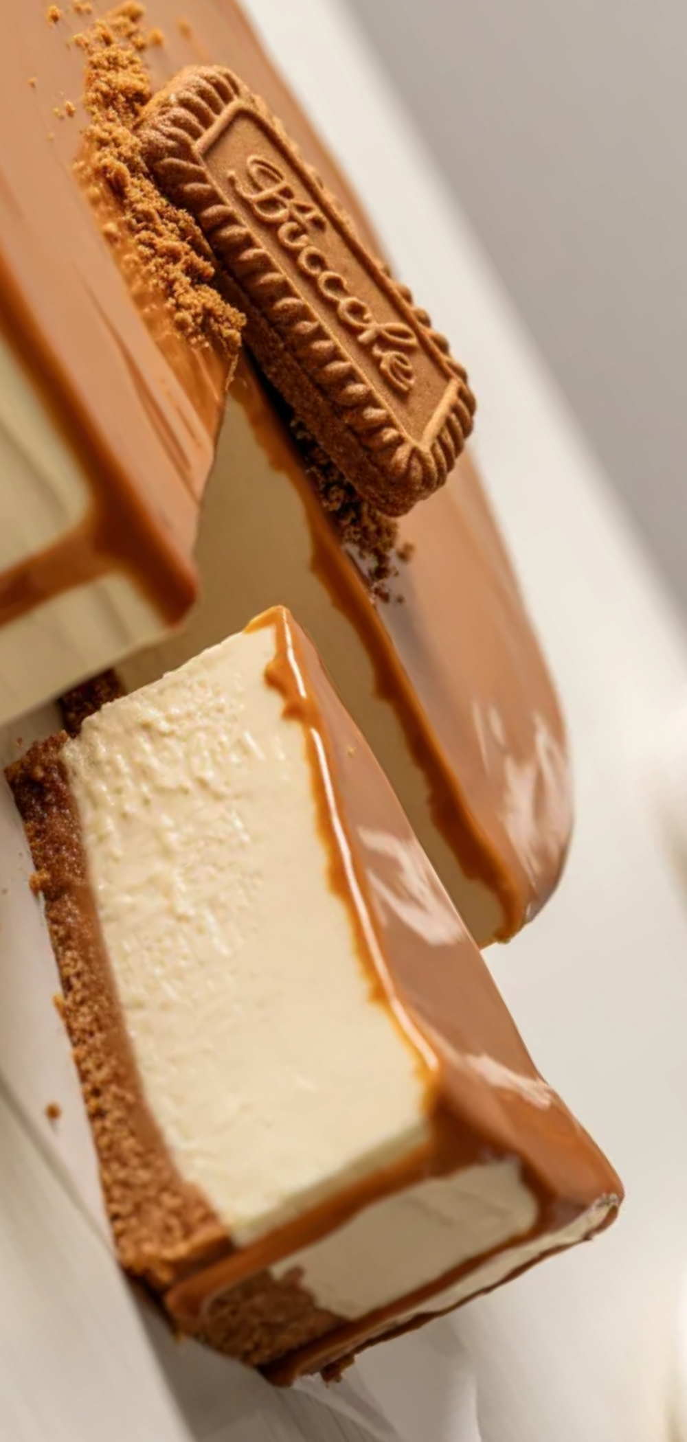 A homemade Biscoff cheesecake slice showing smooth creamy texture and caramel cookie butter topping with crushed biscuits on top